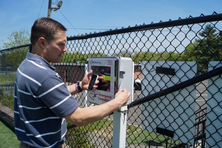 DCP employee checks AED equipment at municipal field